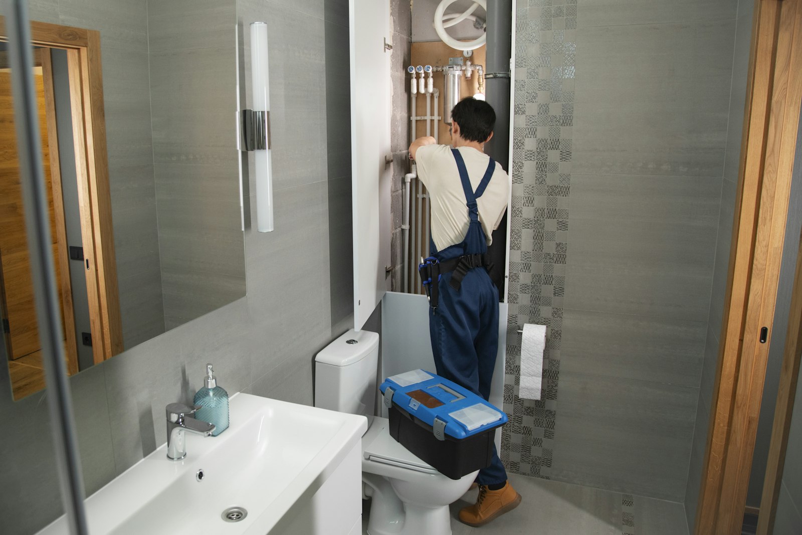Plumber diagnosing a fault under a kitchen sink
