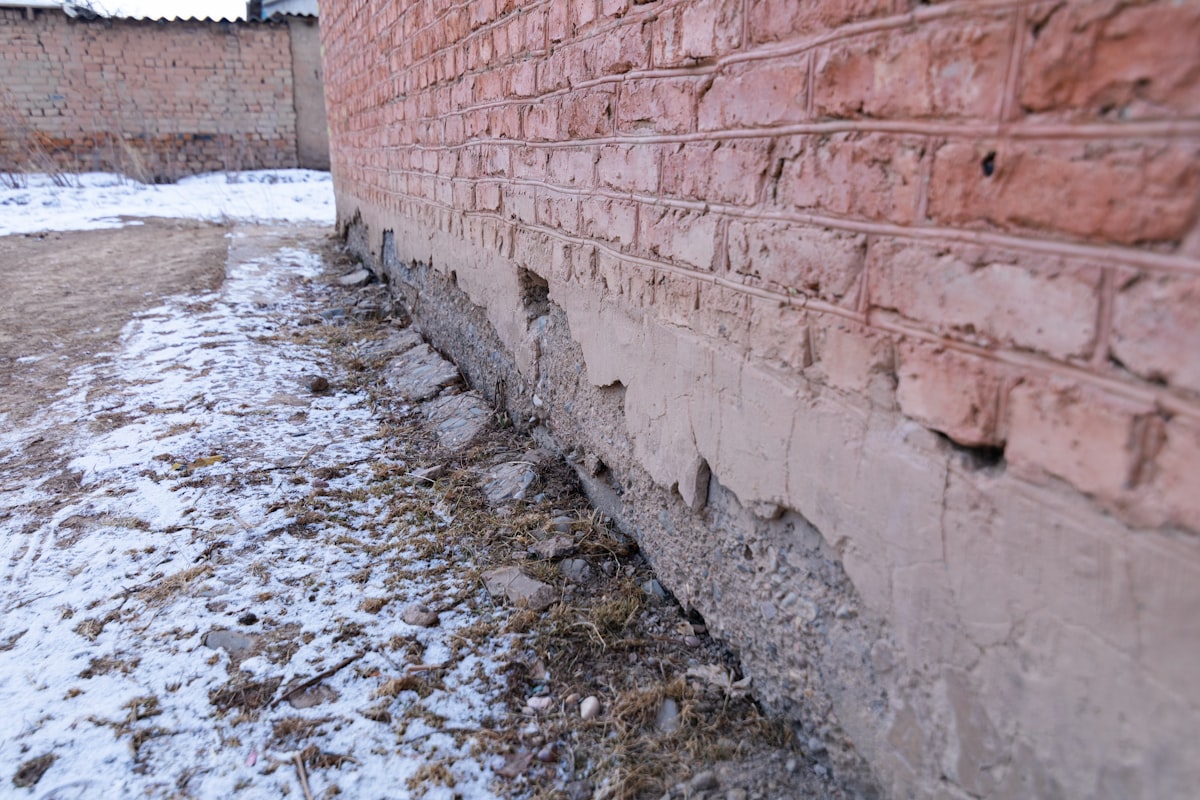 Technician using leak detection equipment on a wall